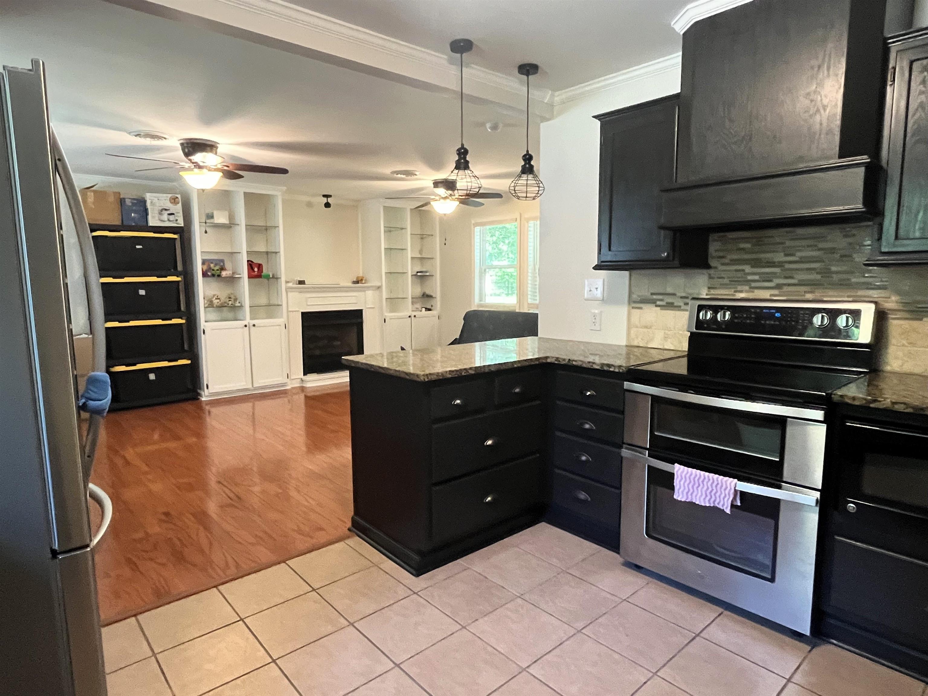 7835 Captain Road Millington, TN 38053 - Photo 12 of 24 a kitchen with stainless steel appliances granite countertop a stove and a sink