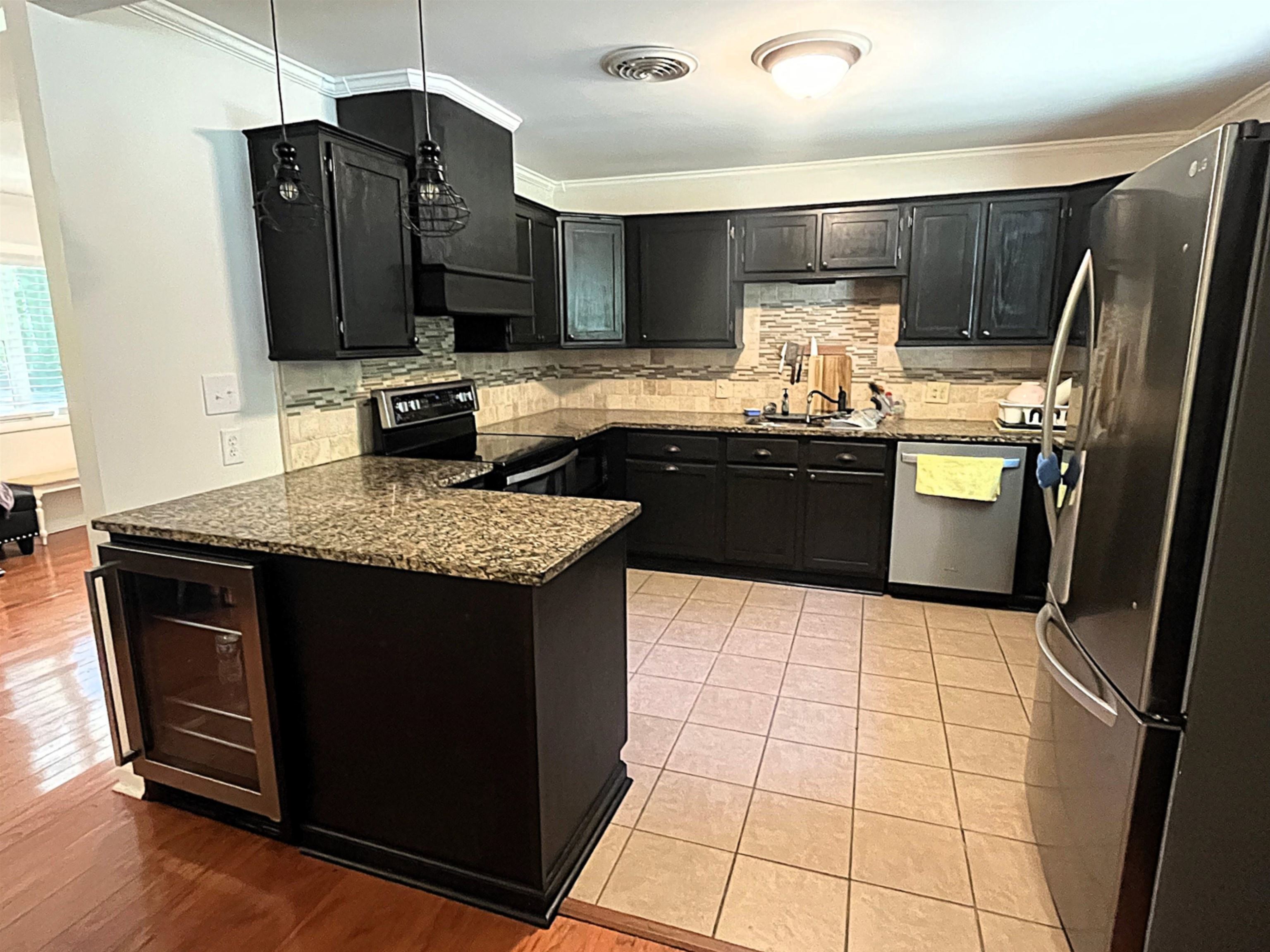 7835 Captain Road Millington, TN 38053 - Photo 13 of 24 a kitchen with stainless steel appliances granite countertop a refrigerator a sink a stove a microwave and island
