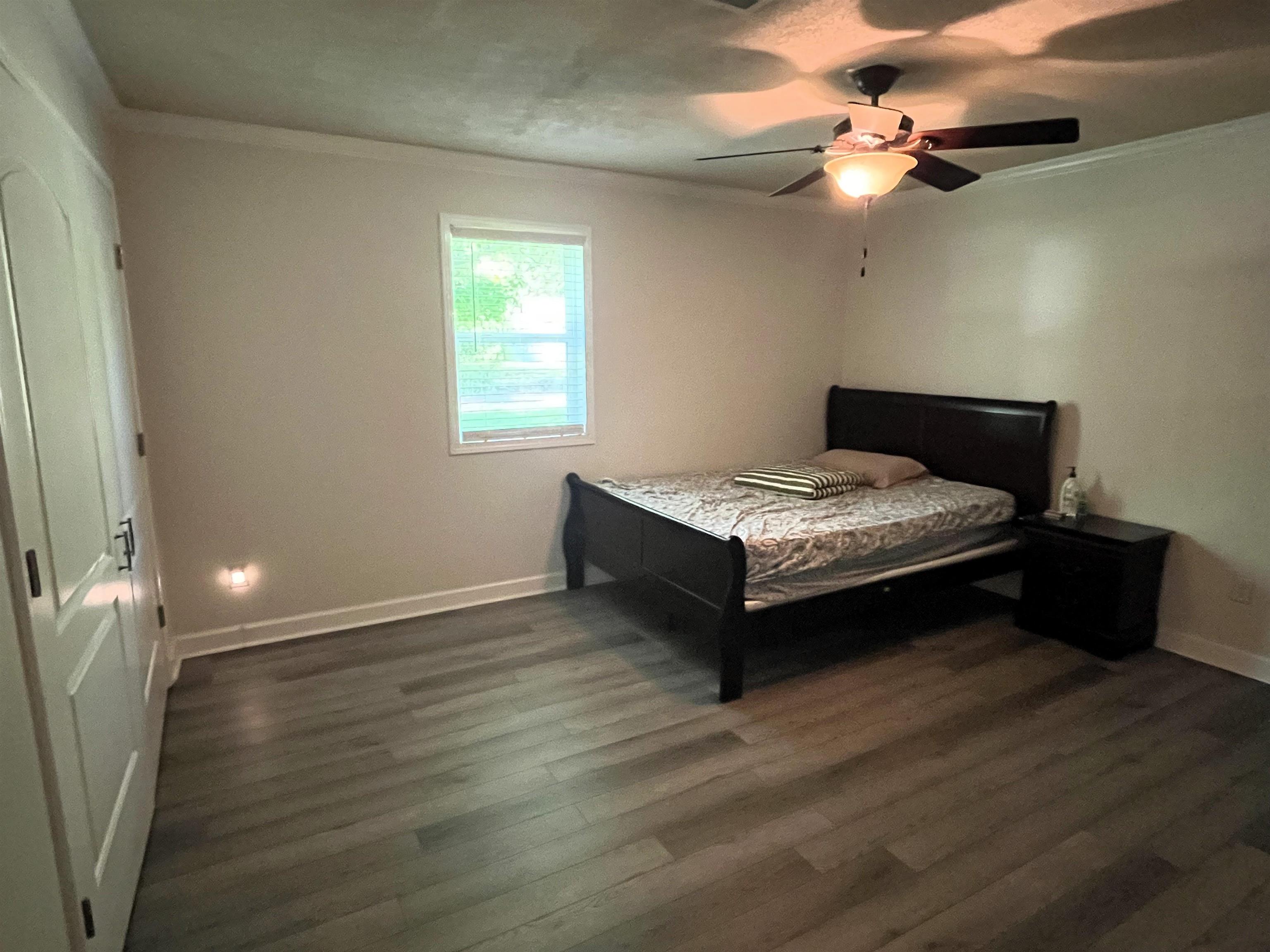 7835 Captain Road Millington, TN 38053 - Photo 14 of 24 a bedroom with a bed and a chandelier