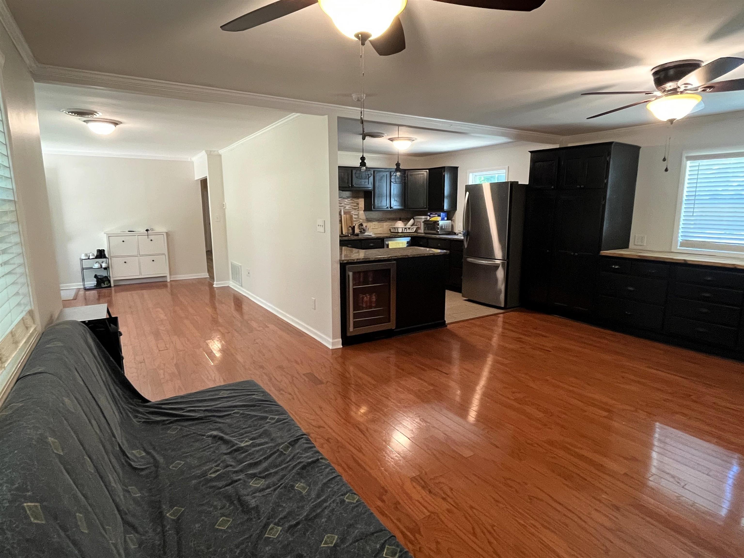 7835 Captain Road Millington, TN 38053 - Photo 8 of 24 a kitchen with stainless steel appliances kitchen island granite countertop a refrigerator a stove and a sink with wooden floor
