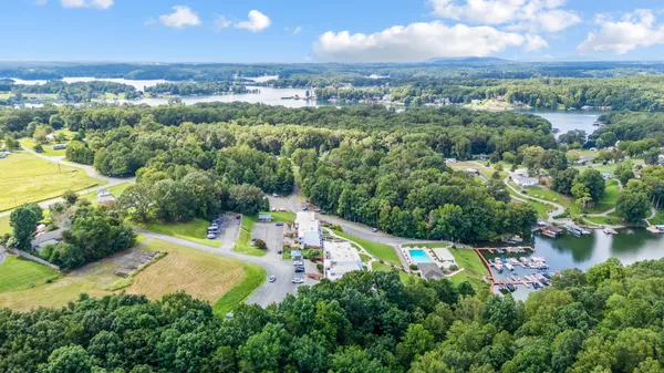 an aerial view of a house with a yard and lake view
