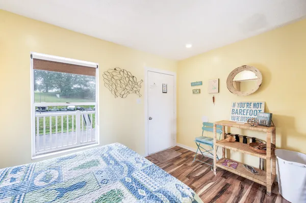 a bedroom with a bed and wooden floor