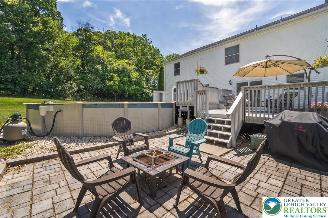 9461 Red Road Kempton, PA 19529 - Photo 41 of 55 An inviting backyard oasis offers a spacious patio, an above-ground pool, and a multi-level deck for outdoor enjoyment.