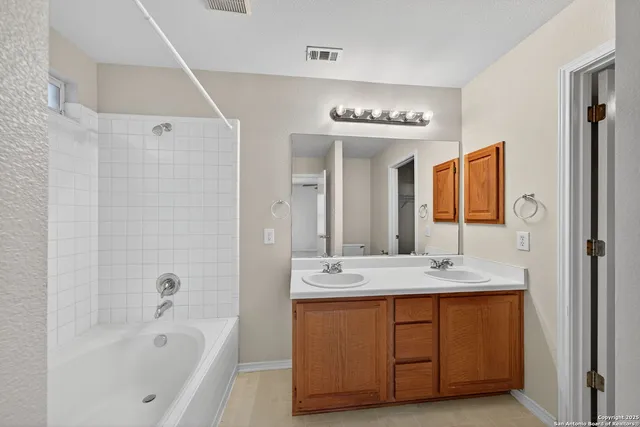 a bathroom with a sink double vanity and a mirror