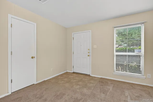 a view of an empty room with a window