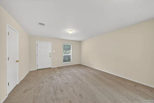 a kitchen with stainless steel appliances granite countertop wooden cabinets a sink a stove a refrigerator and dishwasher with wooden floor