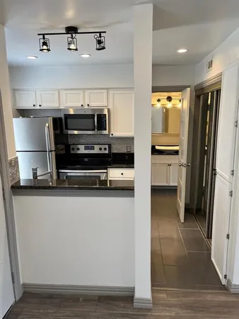 a kitchen with stainless steel appliances a stove a microwave and a sink