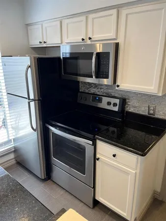 a kitchen with granite countertop a sink and a granite counter tops