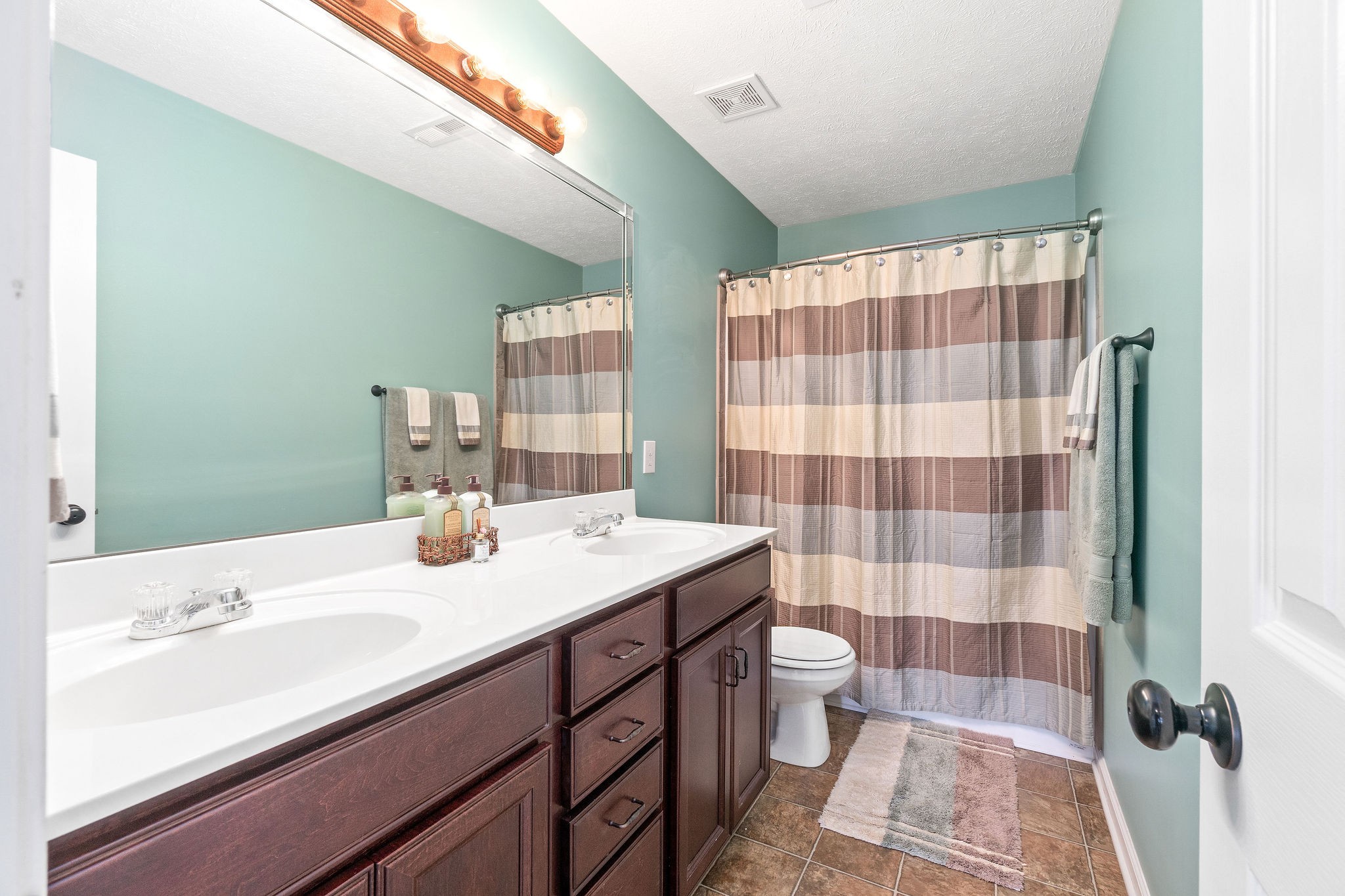 3743 Suiter Road Clarksville, TN 37040 - Photo 25 of 32 a bathroom with a sink a toilet a shower and a mirror