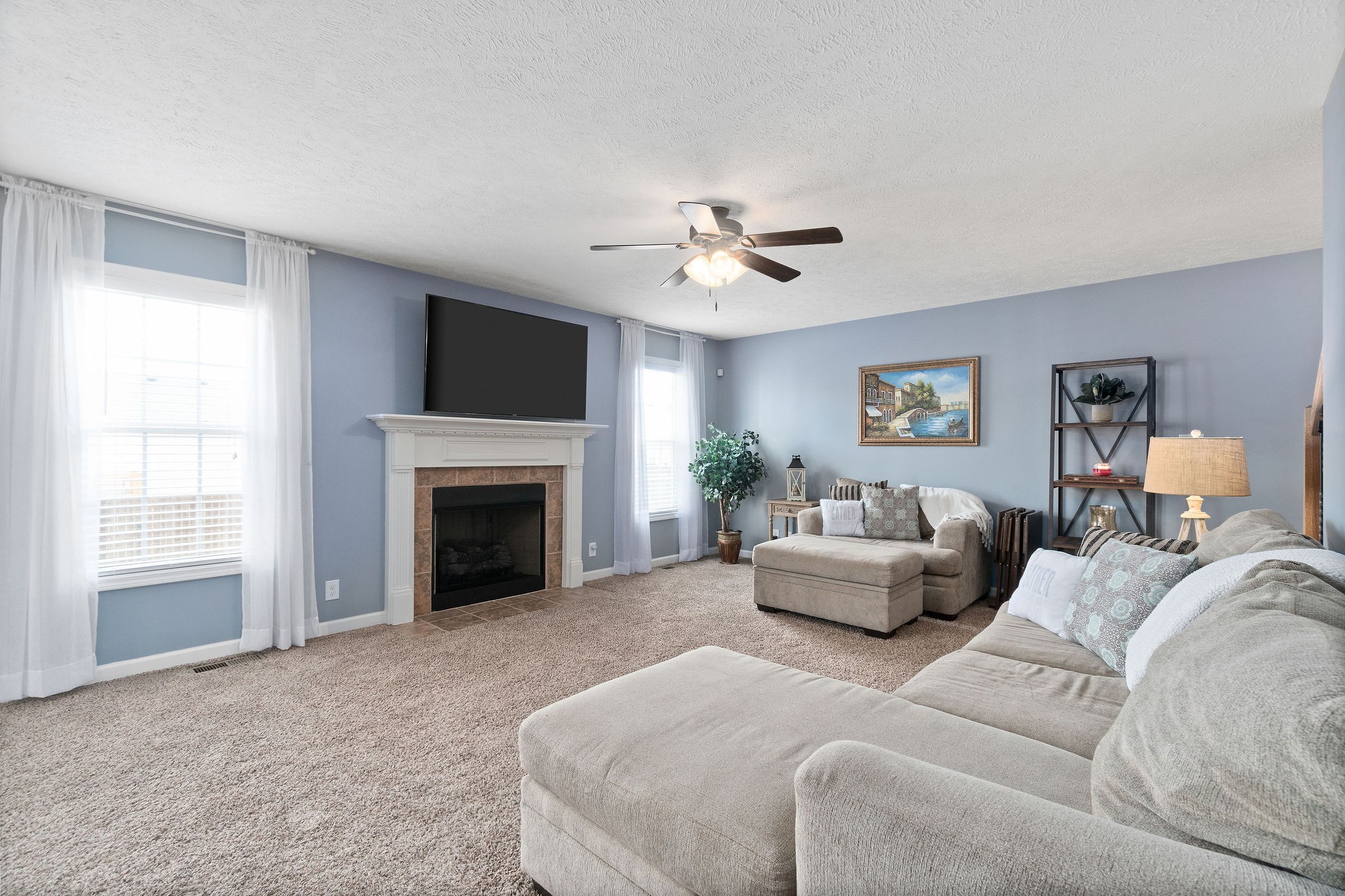 3743 Suiter Road Clarksville, TN 37040 - Photo 6 of 32 a living room with furniture a fireplace and a flat screen tv