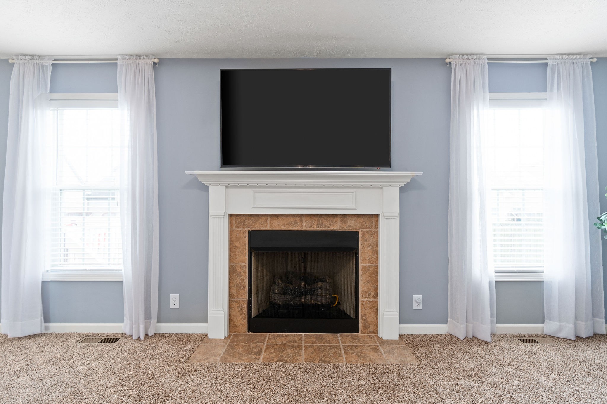 3743 Suiter Road Clarksville, TN 37040 - Photo 7 of 32 a living room with a fireplace and a flat screen tv