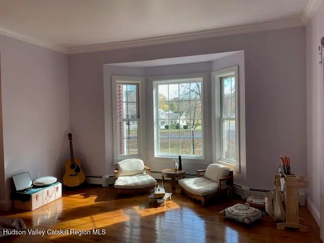 a living room with furniture gym equipment and a large window