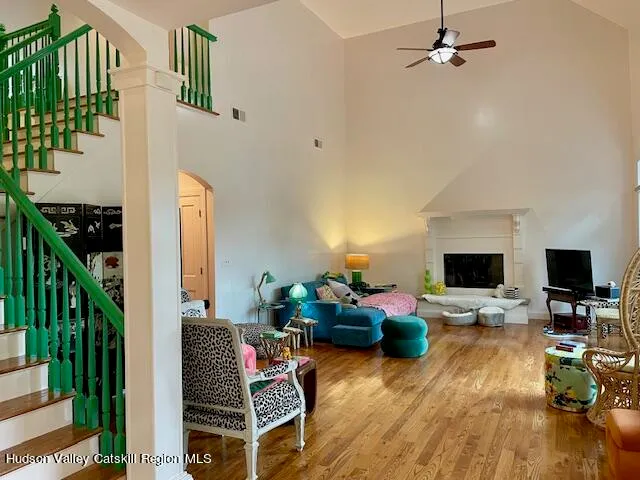a view of a dining room with furniture a rug and wooden floor