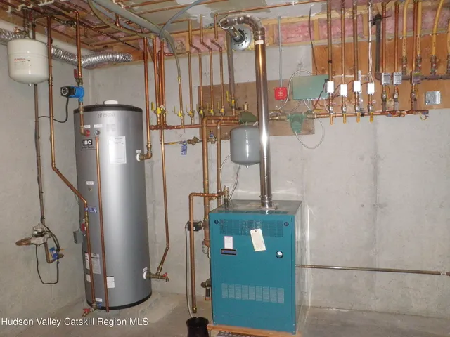 a kitchen with stainless steel appliances kitchen island granite countertop a stove a sink and a refrigerator