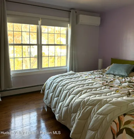 a bed sitting in a bedroom next to a window