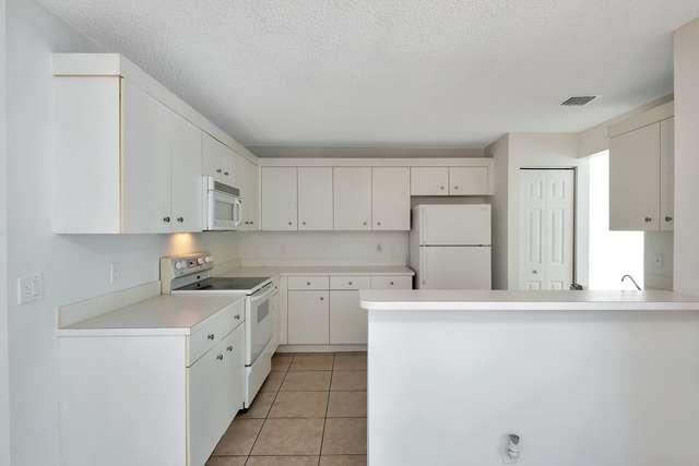 4821 North Lee Road Delray Beach, FL 33445 - Photo 11 of 33 a kitchen with a sink a stove and refrigerator