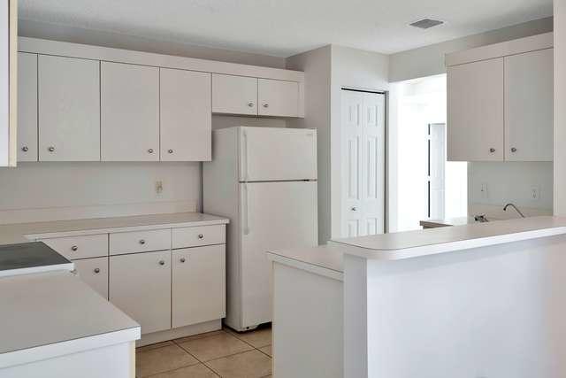 4821 North Lee Road Delray Beach, FL 33445 - Photo 12 of 33 a white refrigerator freezer sitting inside of a kitchen