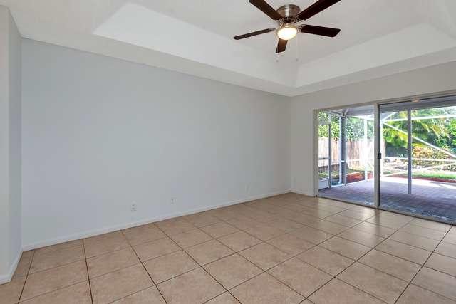 4821 North Lee Road Delray Beach, FL 33445 - Photo 13 of 33 an empty room with windows and fan