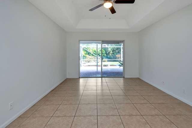 4821 North Lee Road Delray Beach, FL 33445 - Photo 15 of 33 an empty room with windows and ceiling fan