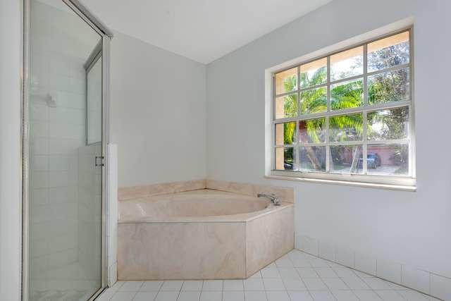 4821 North Lee Road Delray Beach, FL 33445 - Photo 19 of 33 a white bath tub sitting in a bathroom next to a window