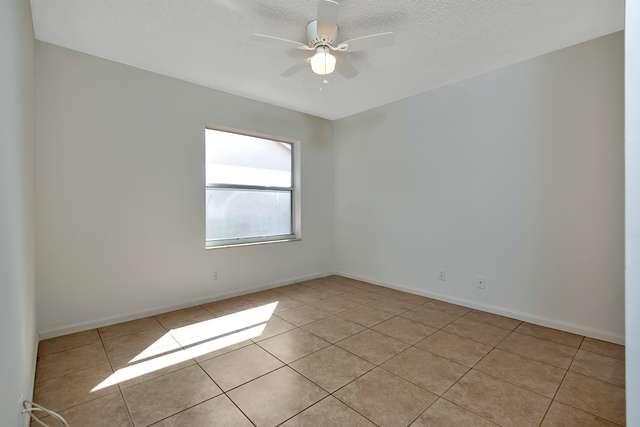 4821 North Lee Road Delray Beach, FL 33445 - Photo 21 of 33 an empty room with windows and fan