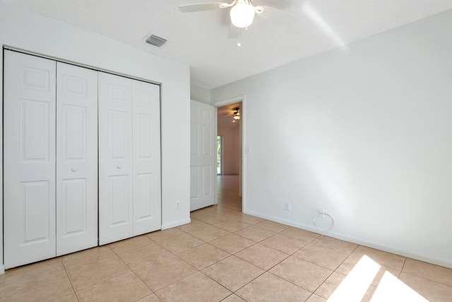 4821 North Lee Road Delray Beach, FL 33445 - Photo 23 of 33 an empty room with a ceiling fan and carpet