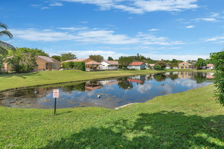 4821 North Lee Road Delray Beach, FL 33445 - Photo 32 of 33 a view of a lake with houses in the back