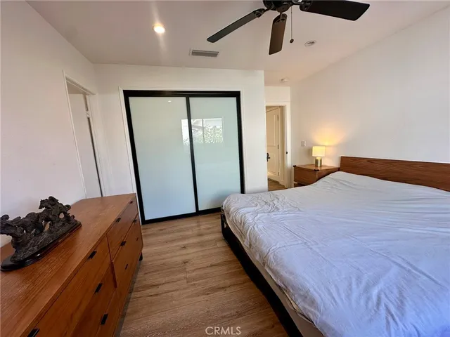 a bedroom with a bed and a mirror