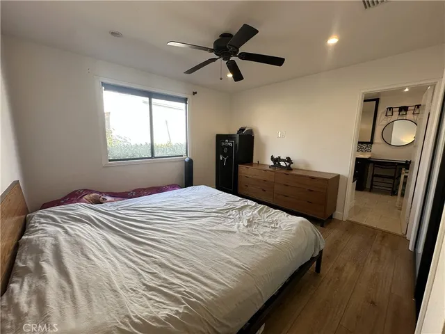 a bedroom with a bed and a ceiling fan