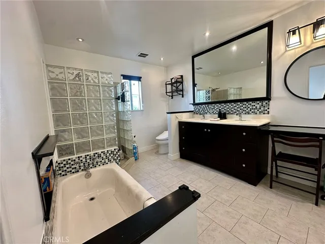 a bathroom with a sink double vanity and a mirror