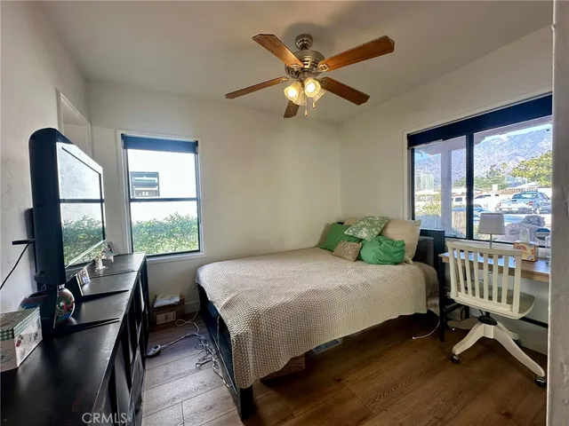 a bedroom with a bed a chandelier and a window