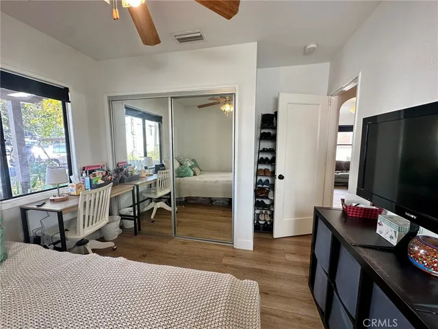 a living room with furniture a desk and chair with the view of living room