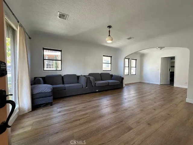 a living room with furniture window and wooden floor