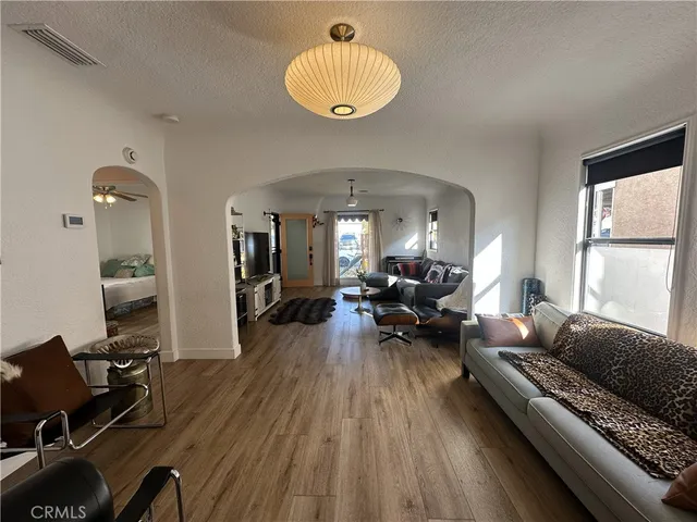 a living room with furniture a window and a chandelier