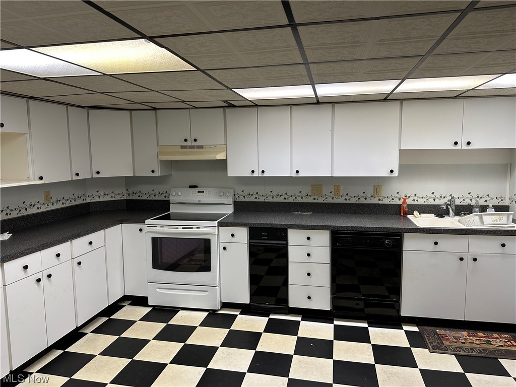 62273 Tacoma Road Barnesville, OH 43713 - Photo 29 of 34 Kitchen featuring a drop ceiling, black dishwasher, white cabinetry, tile flooring, white electric range oven, and dark countertops