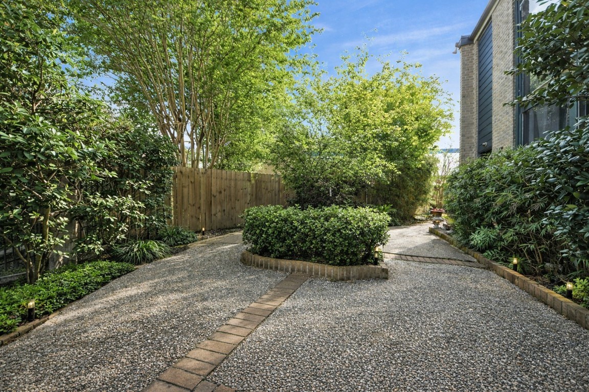 6311 Riverview Way Houston, TX 77057 - Photo 30 of 32 Beautifully maintained courtyard area shared by the townhomes, offering a welcoming and peaceful community setting!