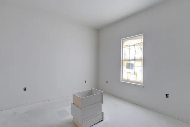 a room that has a window and a dresser
