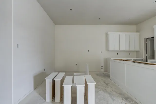 a utility room with wooden floor washer and dryer