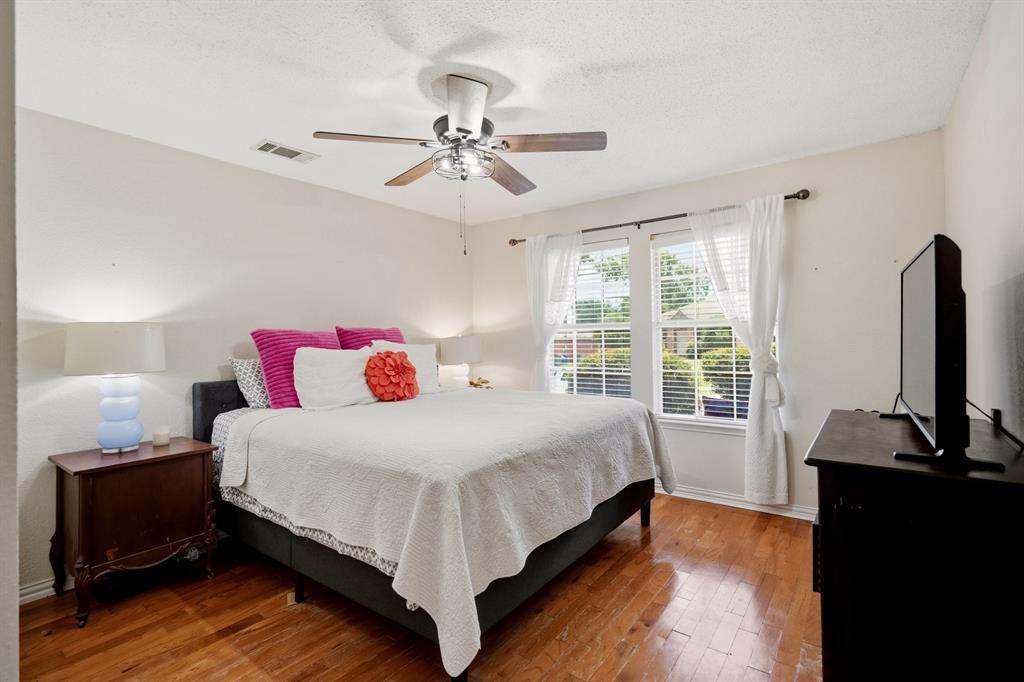 1213 Hampton Drive Forney, TX 75126 - Photo 8 of 27 a bedroom with a bed flat screen tv and window