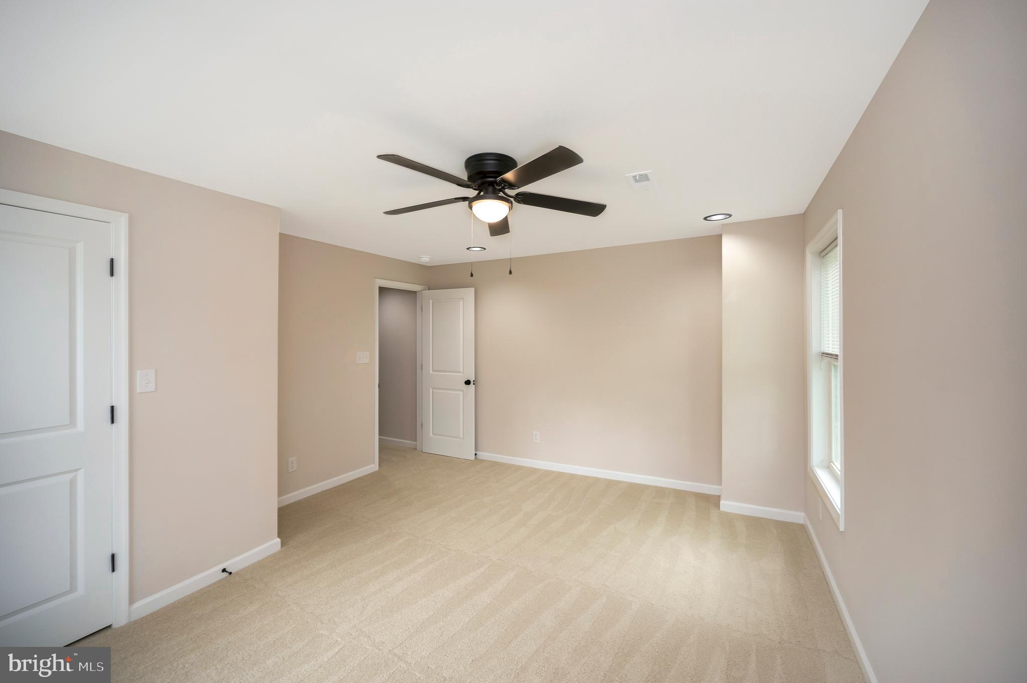 14169 Silver Hill Road Sumerduck, VA 22742 - Photo 29 of 40 a view of an empty room with a ceiling fan