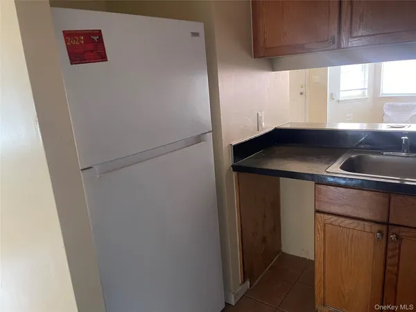 a kitchen with a refrigerator and a sink