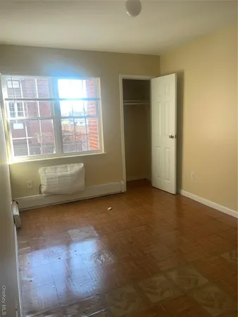 an empty room with a empty space and windows