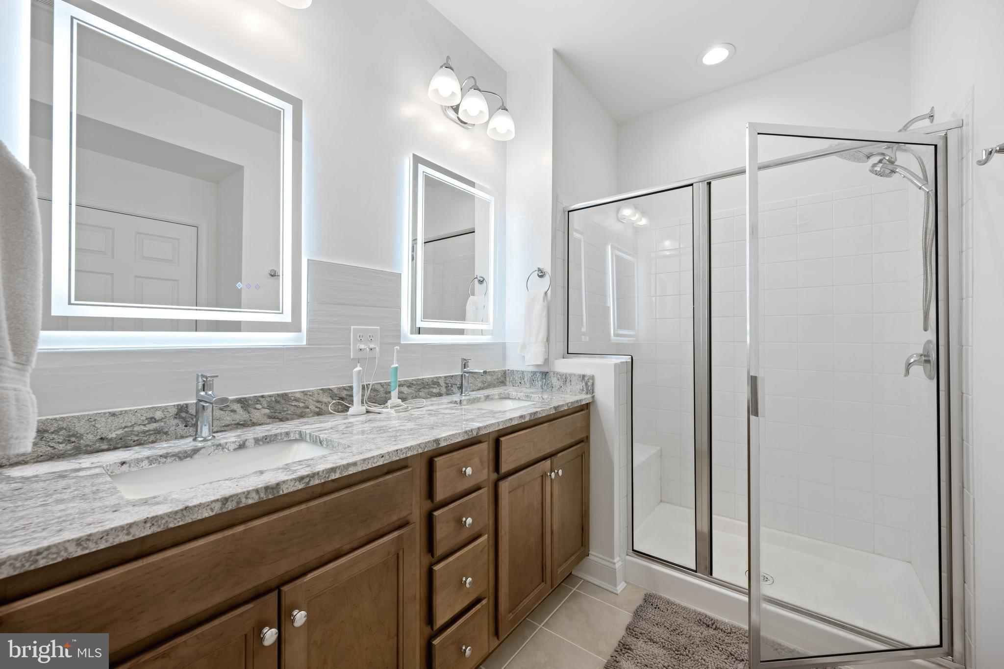 25304 Razorbill Court Millsboro, DE 19966 - Photo 13 of 45 a bathroom with a granite countertop sink mirror and double