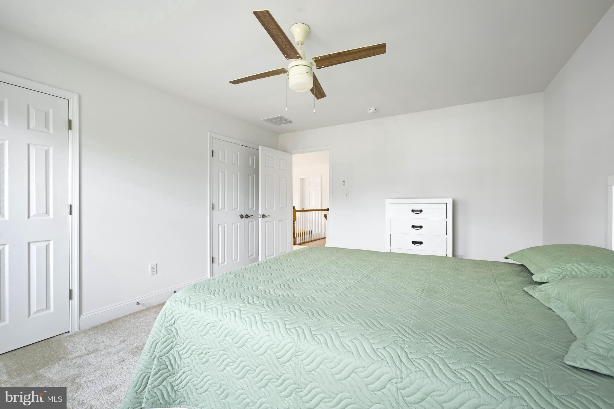 25304 Razorbill Court Millsboro, DE 19966 - Photo 18 of 45 a bedroom with a bed and a ceiling fan