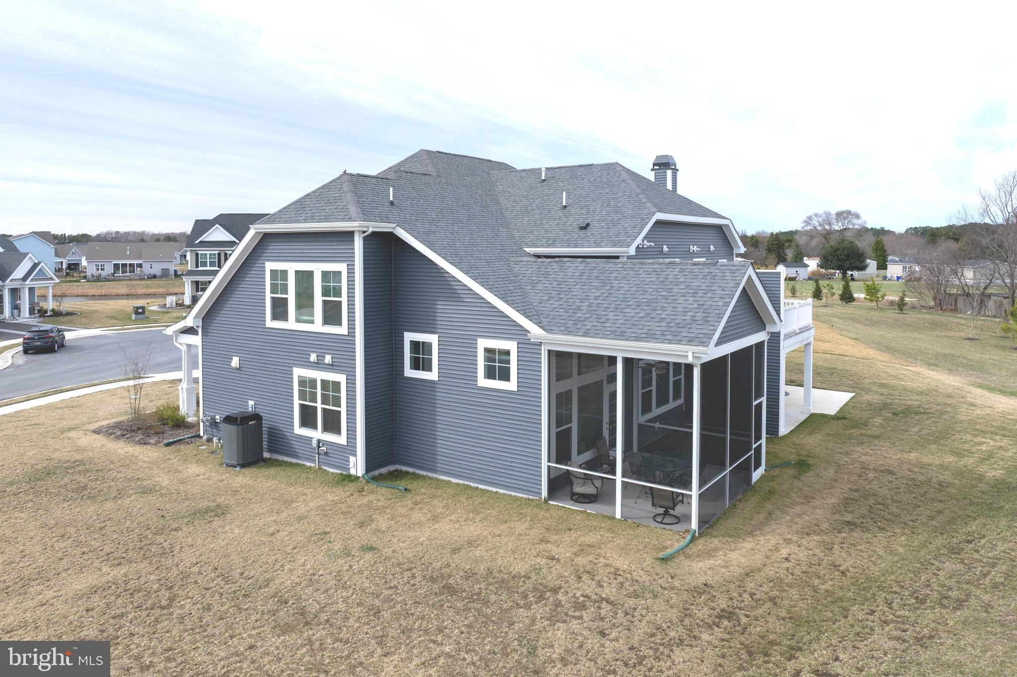 25304 Razorbill Court Millsboro, DE 19966 - Photo 28 of 45 a view of a house with backyard and trees in the background