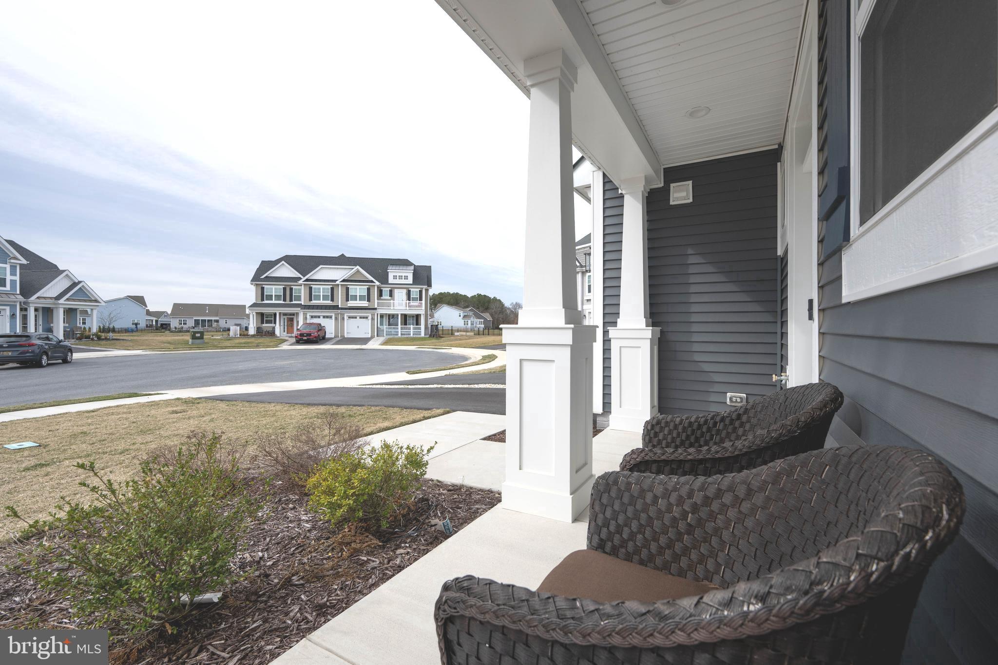 25304 Razorbill Court Millsboro, DE 19966 - Photo 31 of 45 a living room with furniture and a floor to ceiling window