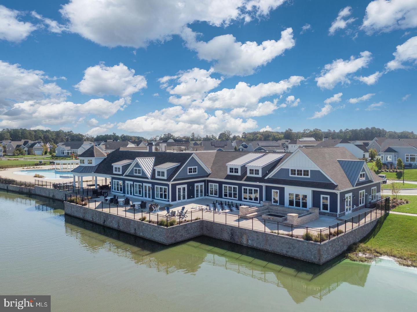 25304 Razorbill Court Millsboro, DE 19966 - Photo 37 of 45 a view of a lake with a large building