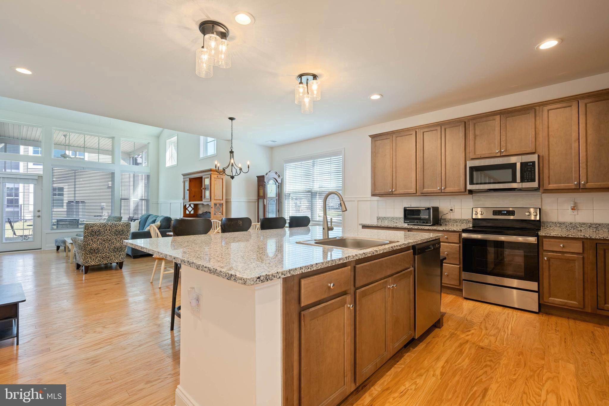 25304 Razorbill Court Millsboro, DE 19966 - Photo 4 of 45 a kitchen with sink a stove and cabinets