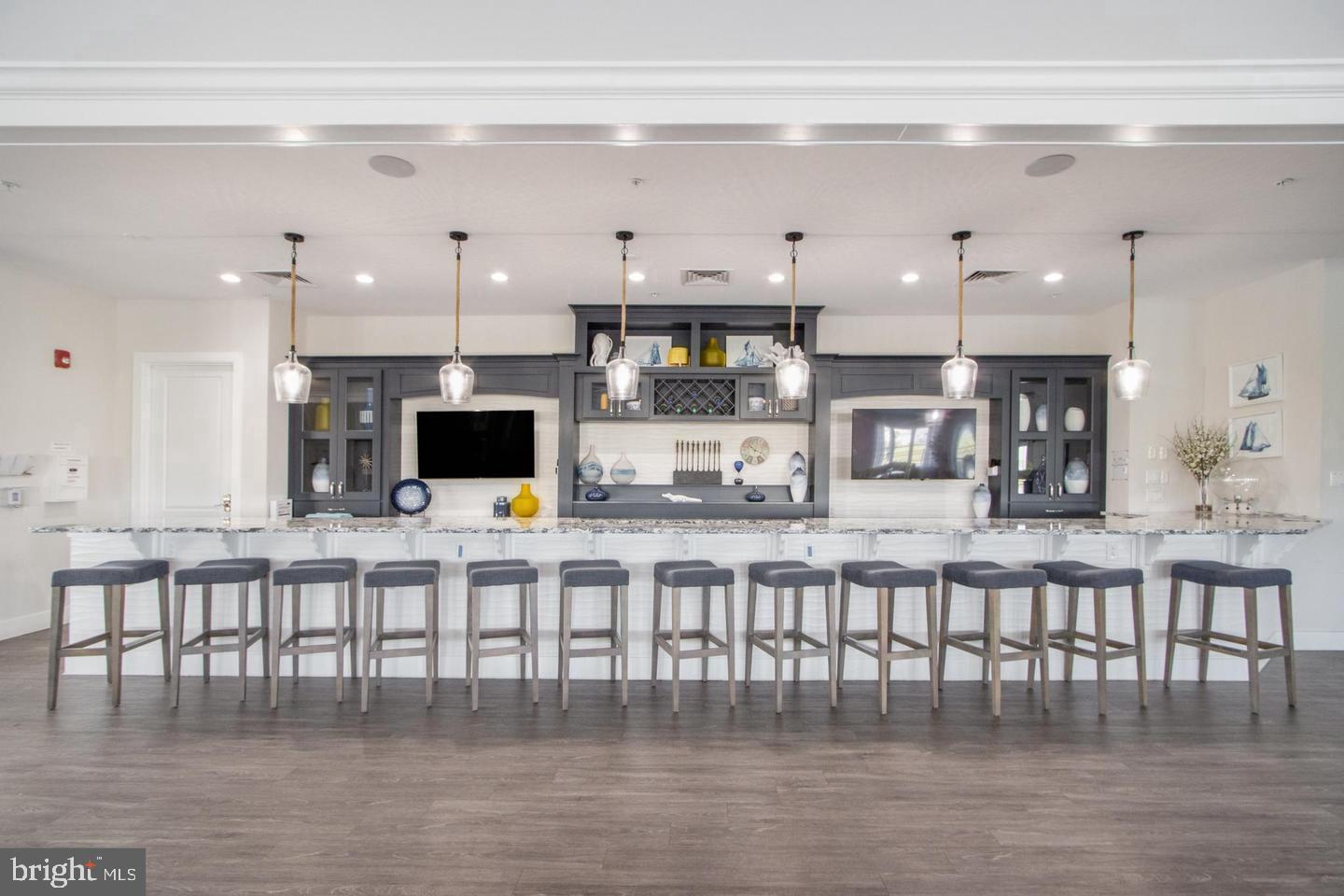 25304 Razorbill Court Millsboro, DE 19966 - Photo 41 of 45 a kitchen with stainless steel appliances cabinets and a dining table
