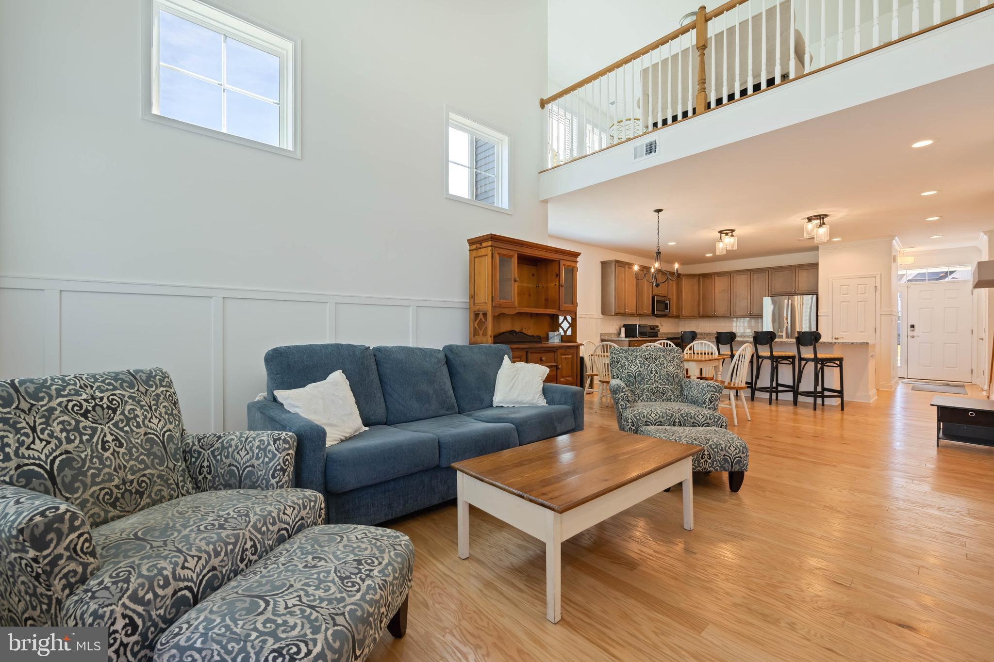 25304 Razorbill Court Millsboro, DE 19966 - Photo 8 of 45 a living room with furniture and kitchen view
